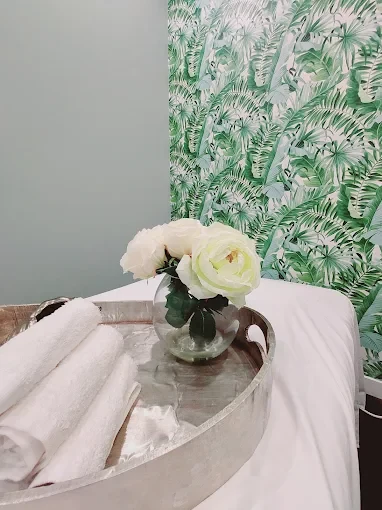 Fresh towels and roses on a treatment table